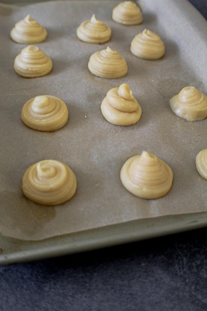 Raw-Cream-Puffs-on-a-parchemnt-lined-baking-sheet