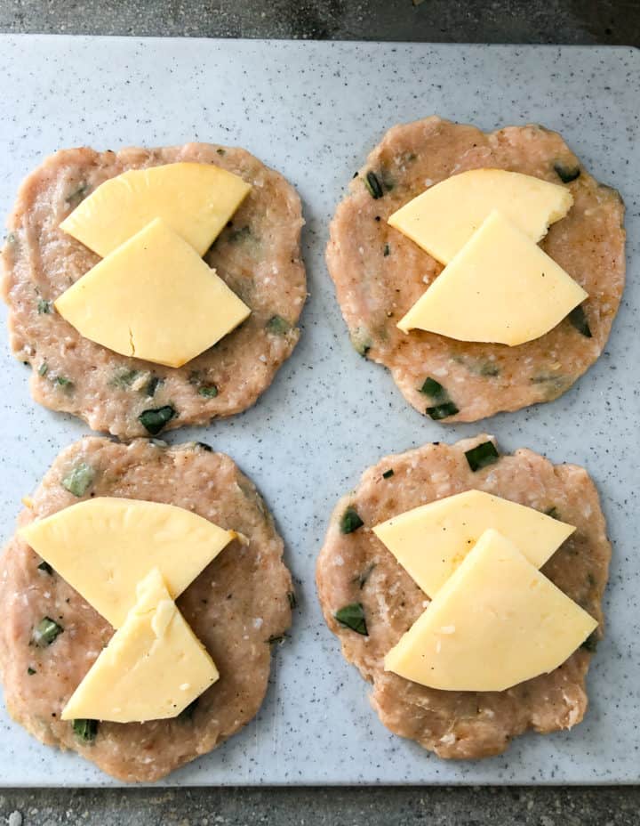 table view turkey burger patties with gouda cheese slices