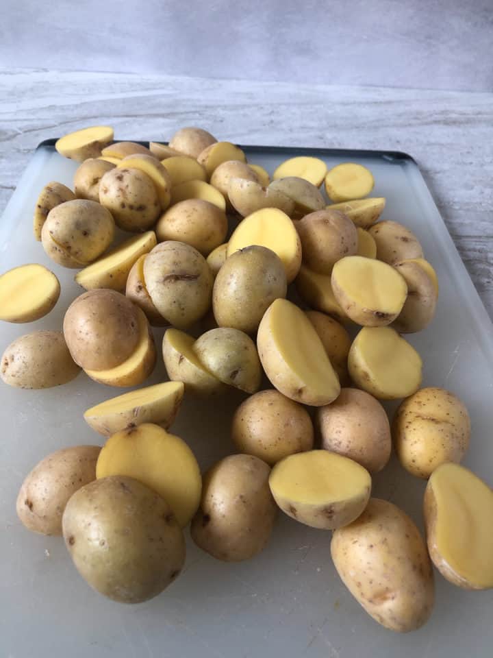 halved potatoes on cutting board