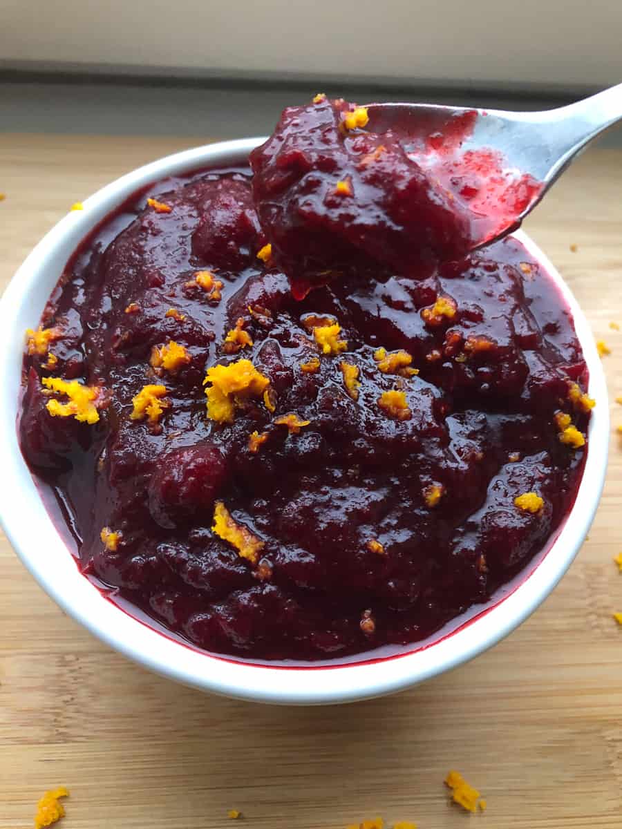 Cranberry sauce in a bowl with spoon