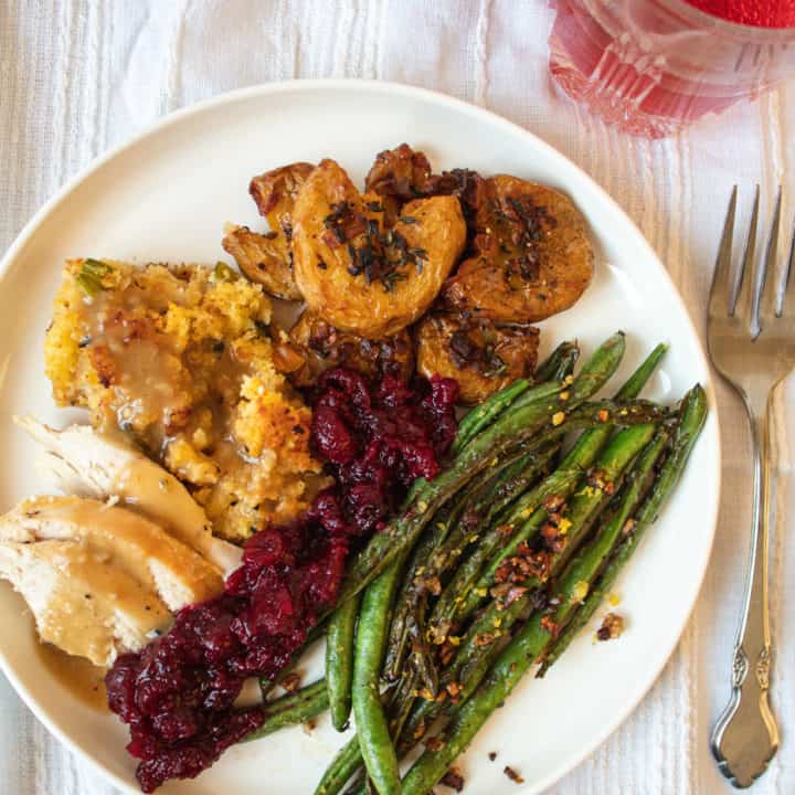 Overhead shot of Sheet Pan Thanksgiving dinner on plate beside a fork
