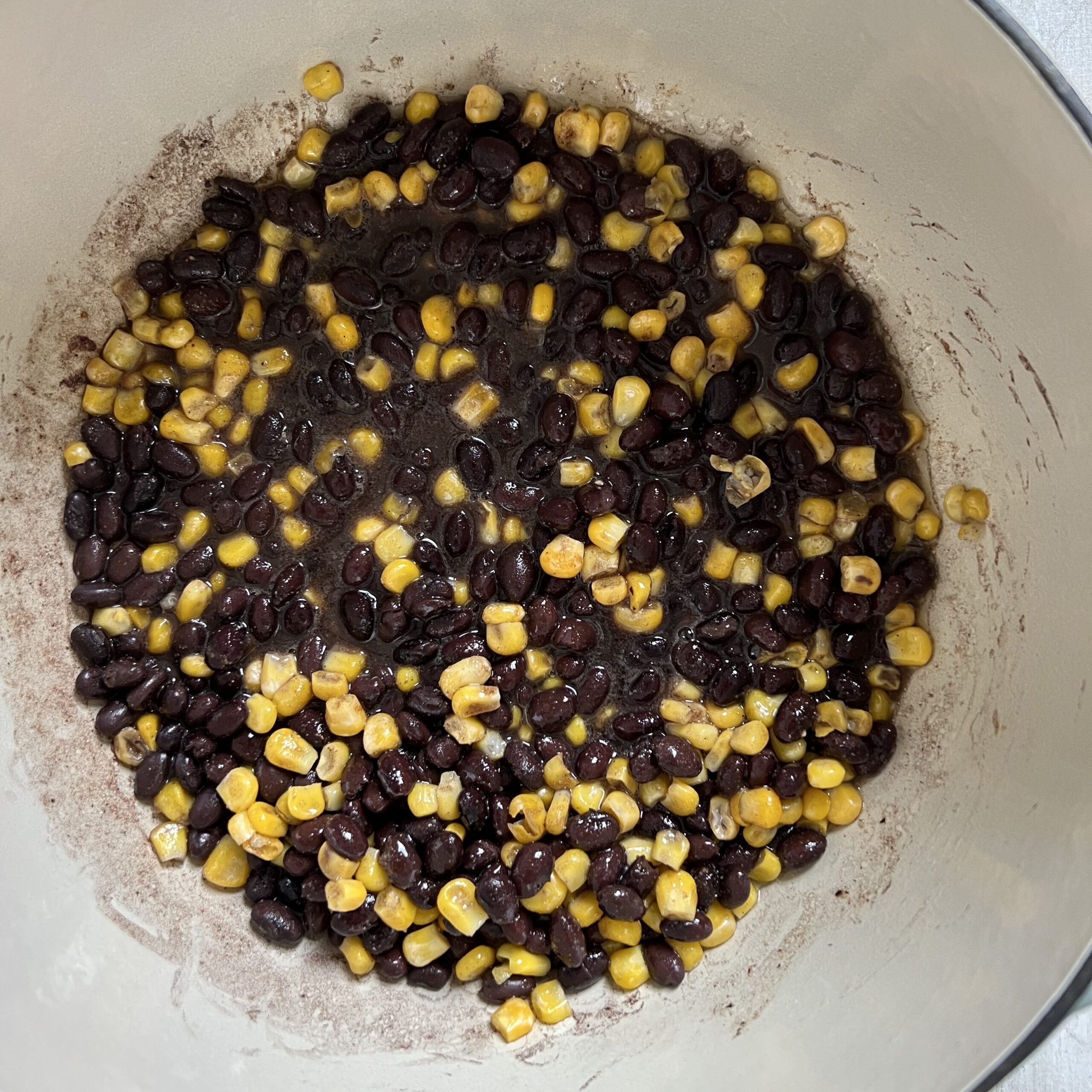White ceramic pot with black beans and corn.